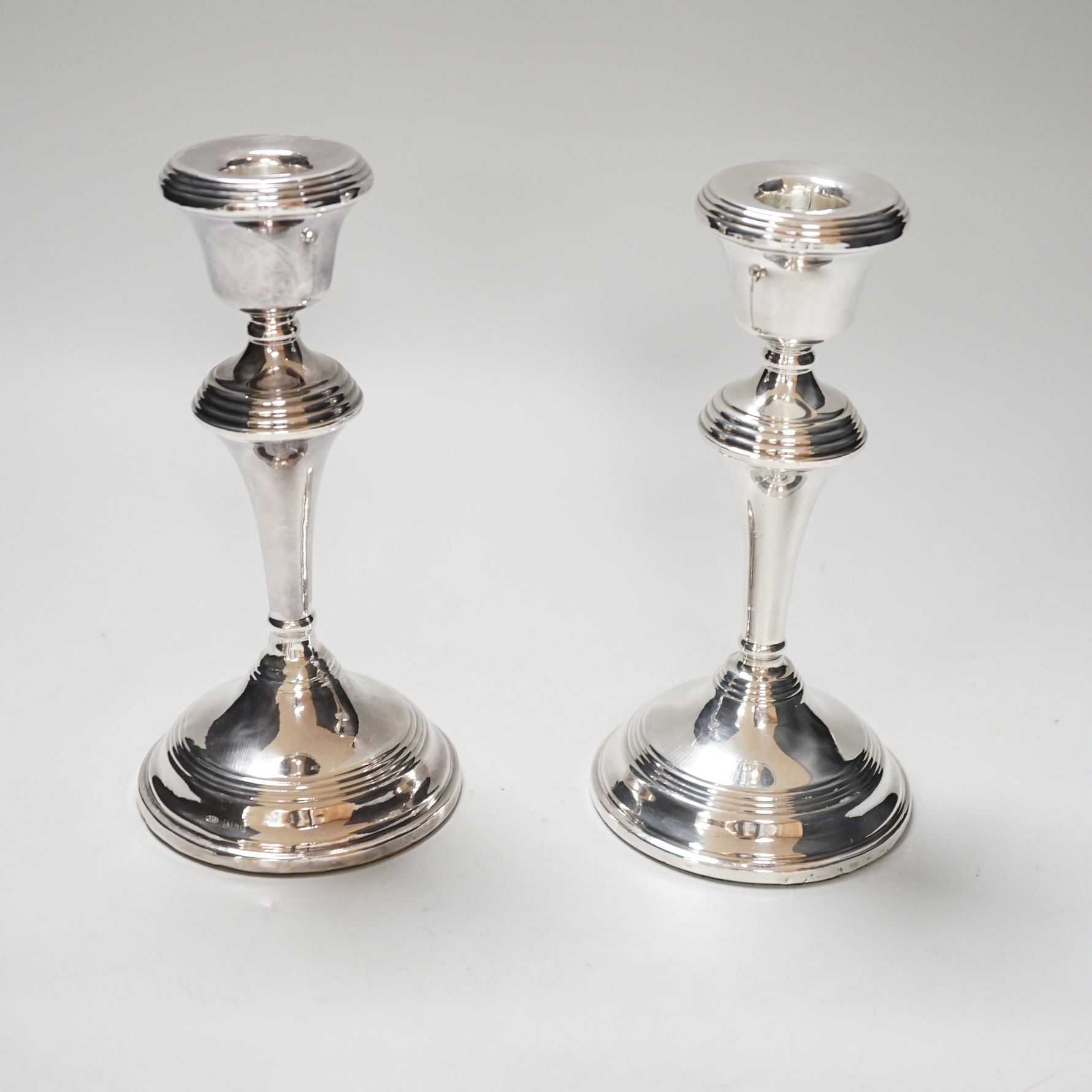 A pair of Elizabeth II silver candlesticks, loaded, Birmingham 1959, 17.5cm
